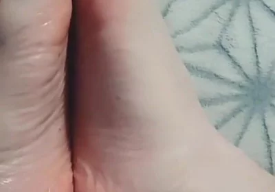 Guy Gently Massages His Feet with Oil